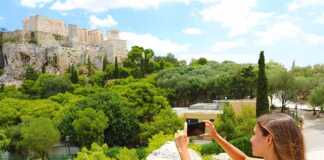 Young Woman Takes A Picture Of The Acropolis