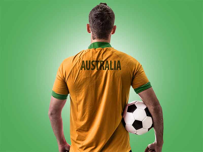 australian sports trivia man with spors shirt holding a soccer ball