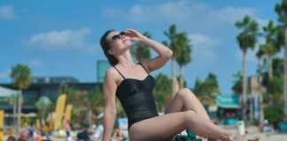 Girl On The Beach Posing Against The Backdrop