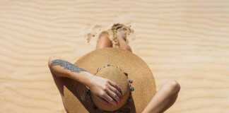 Top view of woman wearing straw hat on beach
