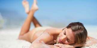woman lying on the sand on the beach