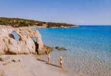 20 Beaches in Greece That Look Too Perfect to Be Real (You Won’t Believe #7) beaches in athens greece couple on the beach