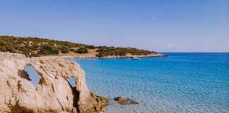 20 Beaches in Greece That Look Too Perfect to Be Real (You Won’t Believe #7) beaches in athens greece couple on the beach