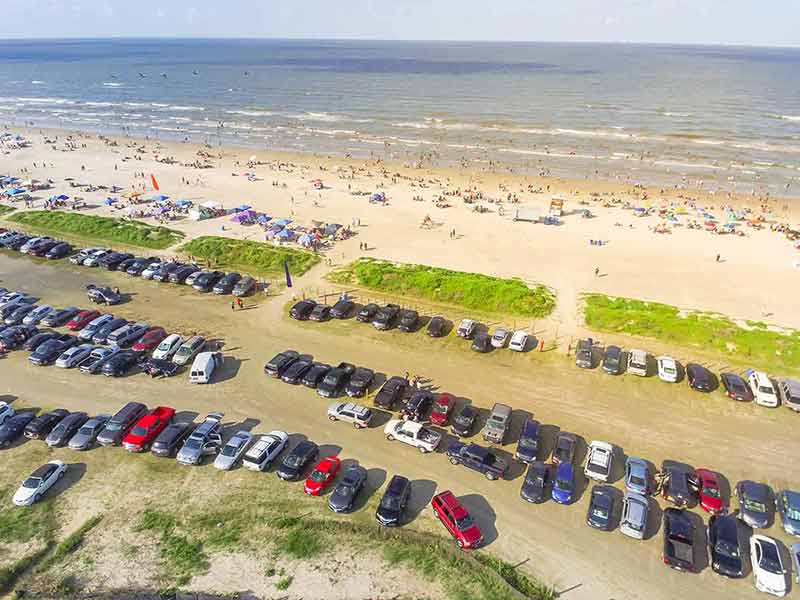 beaches in galveston texas parking lot and sandy Galveston beach