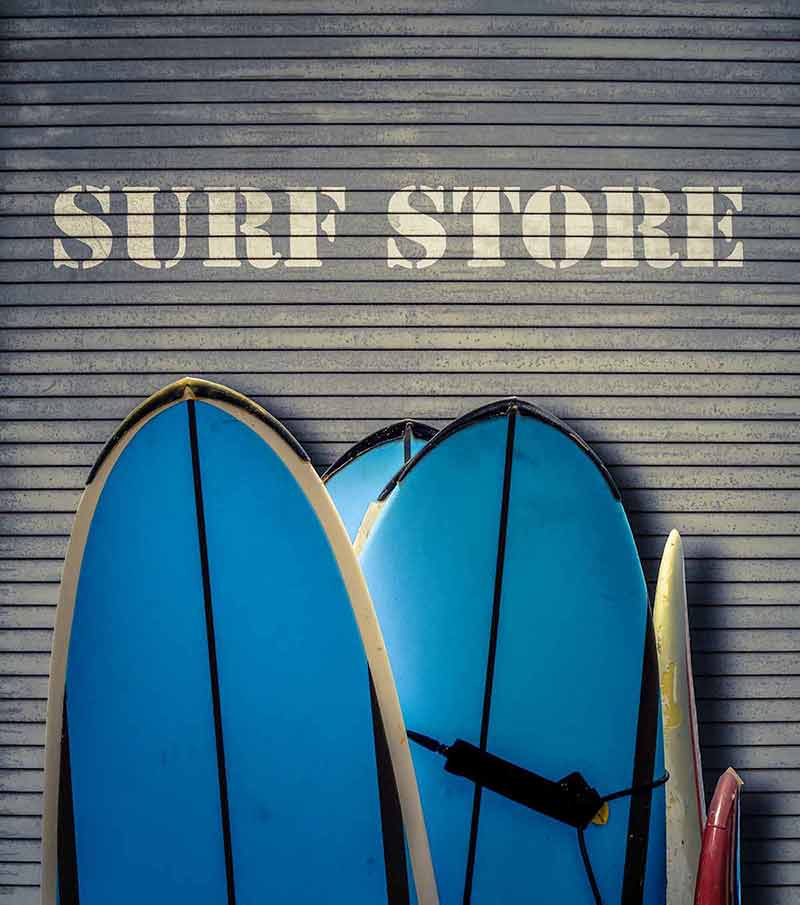beaches in new hampshire with boardwalks Retro Filtered Surf Store Sign With Blue Surfboards.