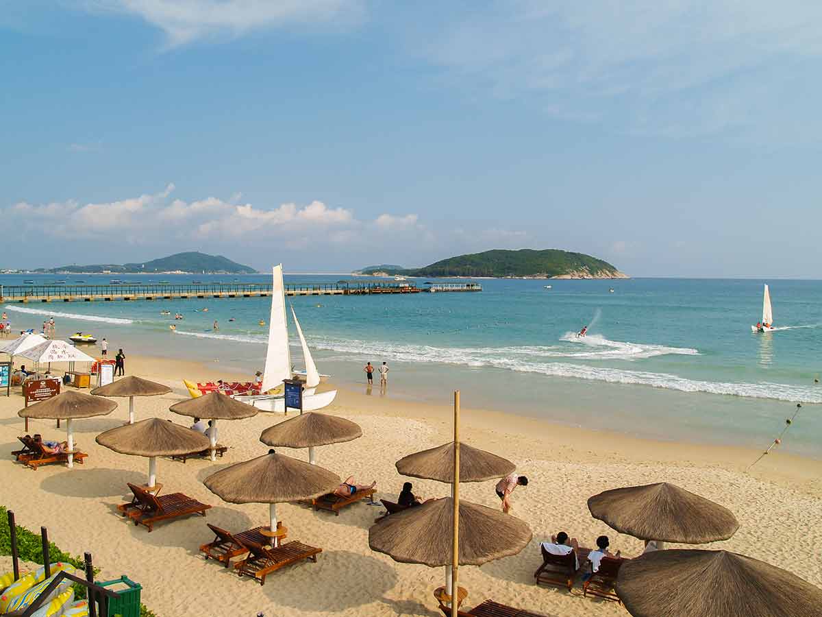 beaches of china (Yalong Bay) beach umbrellas and timber beach lounges