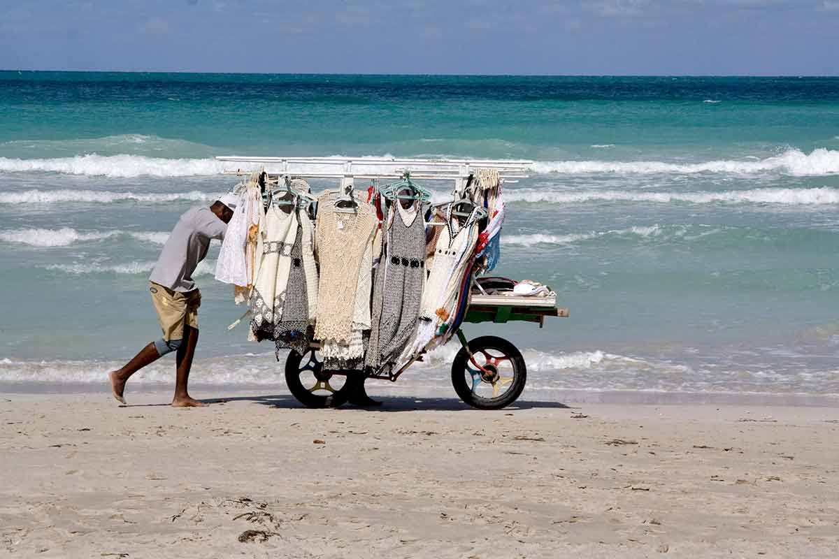 beaches of cuba Beach vendor pushing cart of clothing