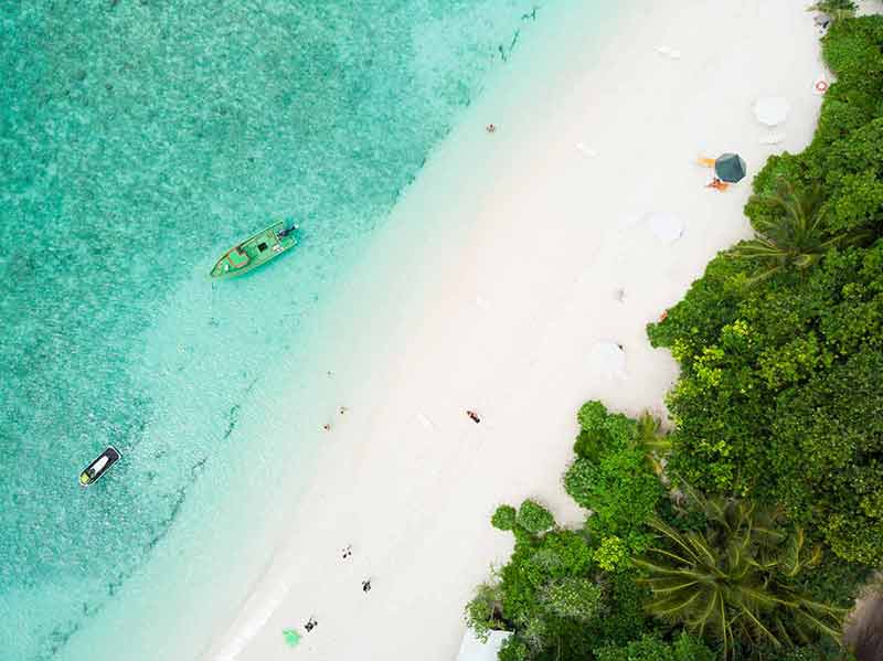 beaches of maldives Aerial drone view of picture perfect beach and turquoise lagoon on small tropical island on Maldives.