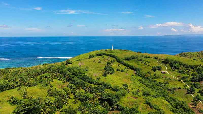 beaches philippines Lighthouse on a tropical island, top view. Beautiful landscape with a green island.