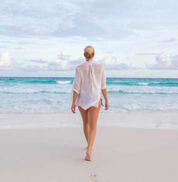beaches seychelles woman in white see-through beach shirt