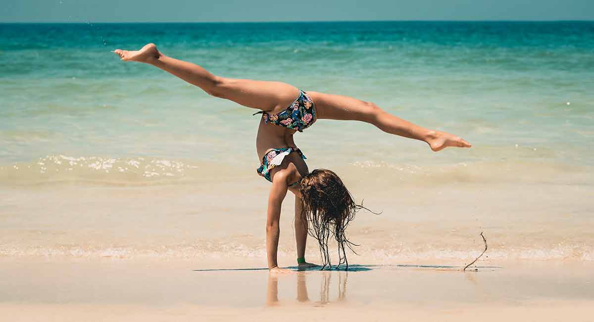 beaches split croatia girl in bikini doing a handstand and splits