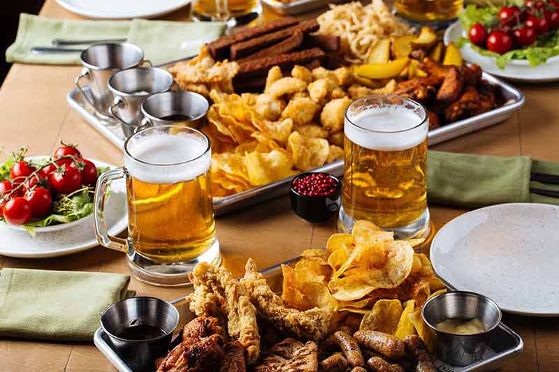 best bars in west hollywood Table set with beer and salty snacks in a pub