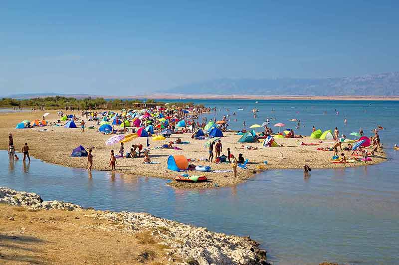 best beaches croatia packed with umbrellas and people sunbathing