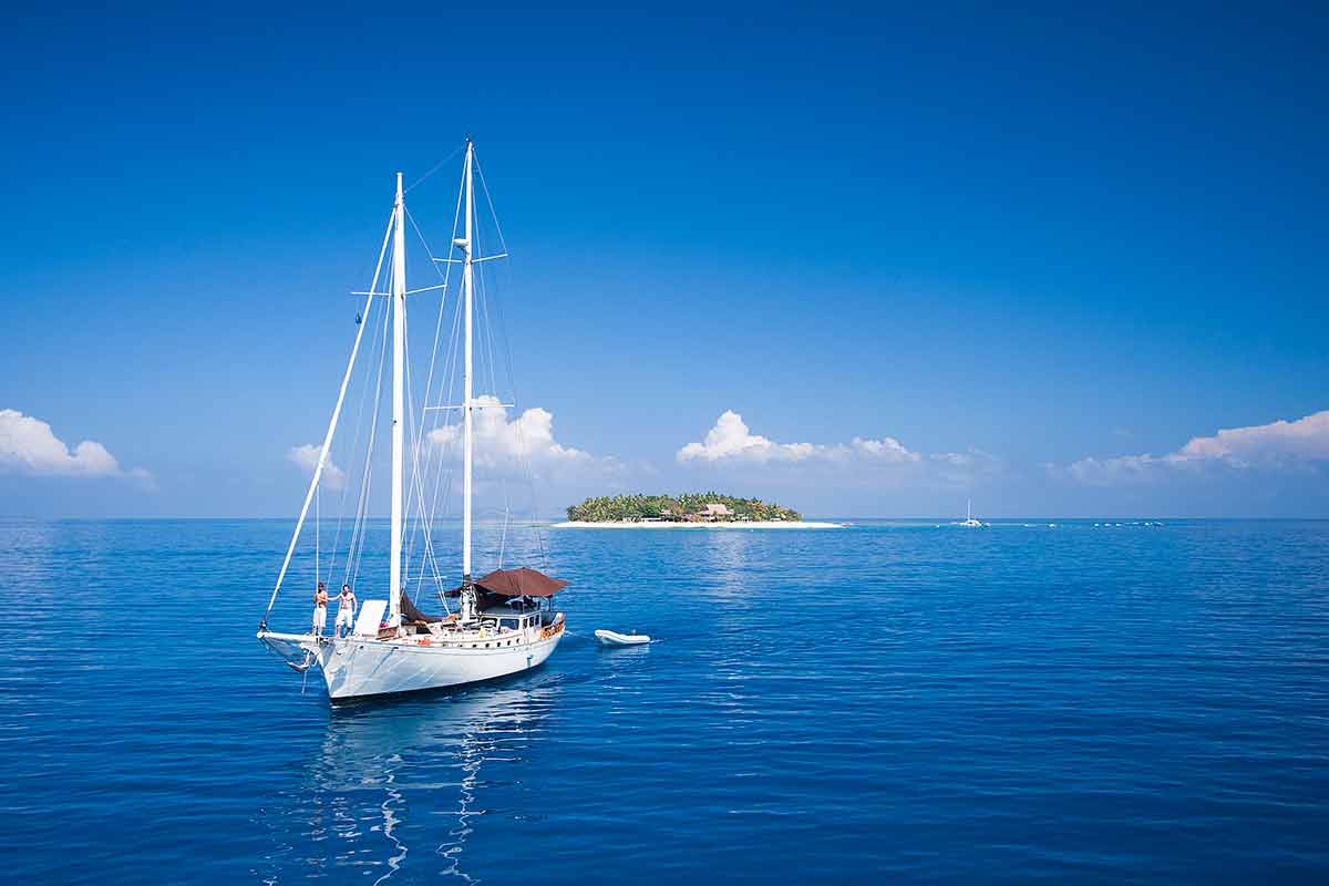 best beaches fiji blue water and sky with sailing boat and island