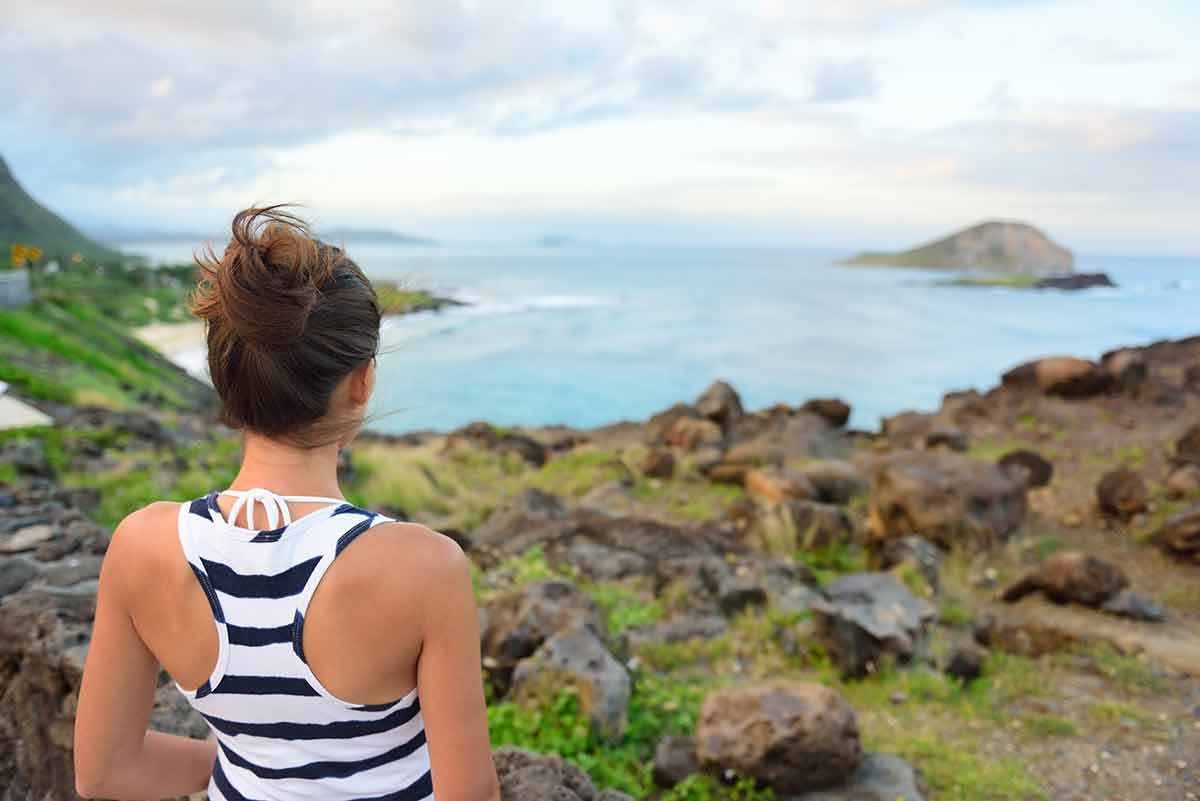 best beaches hawaii woman at makapuu lookout view of Waimanalo beach