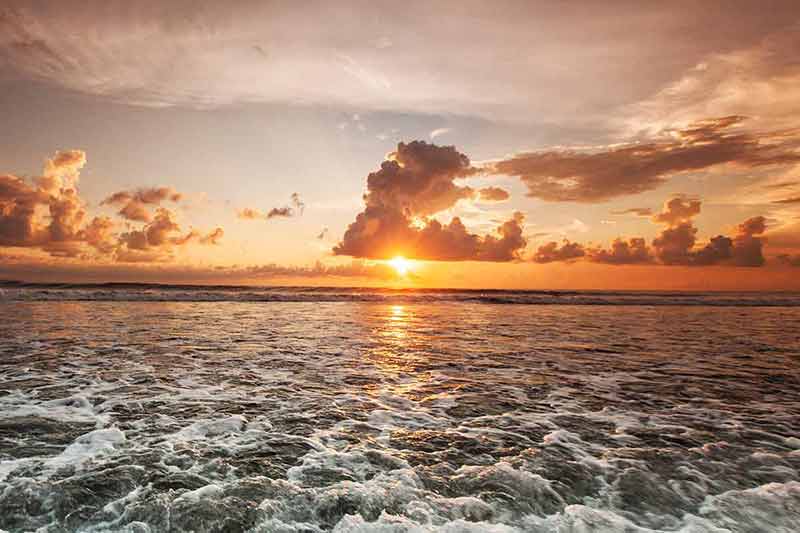 best beaches in cayman islands sunset and frothy waves