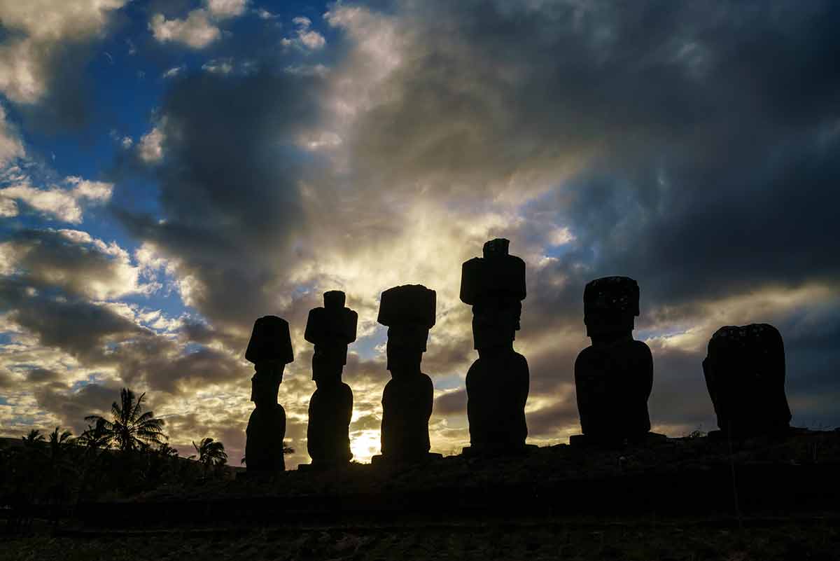 best beaches in chile south America Silhouette shot of Moais at Anakena beach in Easter Island Chile sunset