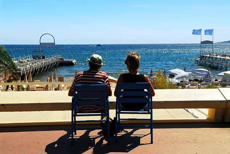best beaches in french riviera for families Couple relaxing in chairs in Cannes