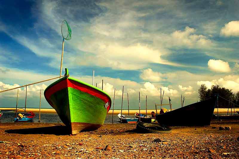 best beaches in malaysia 2016 green fishing boat on the beach with others moored in the water