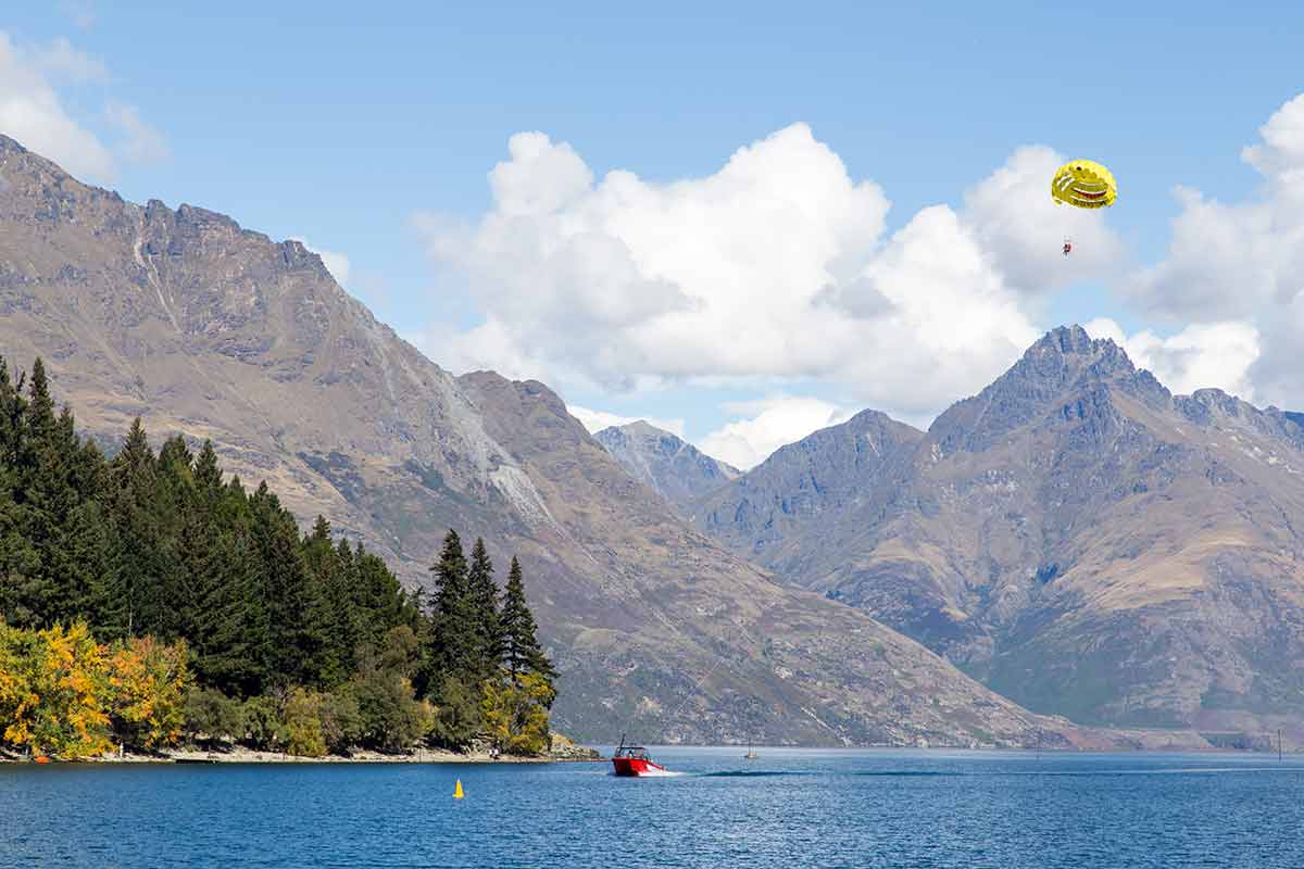 best beaches in new zealand A parasailing boat on Lake Wakatipu