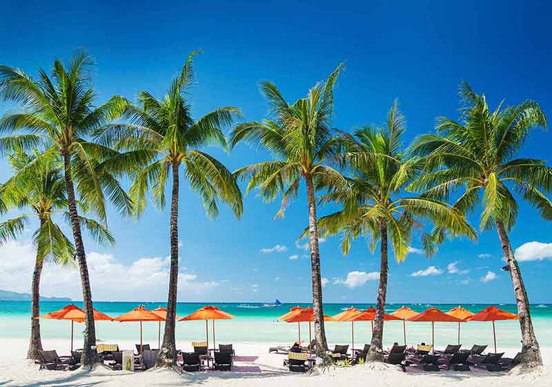 best beaches in the philippines White beach lounge bar chairs and umbrellas on Boracay tropical island in Philippines