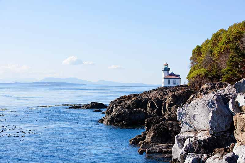 best beaches seattle lighthouse and rocky cliffs