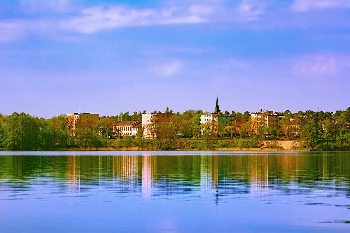 best cities in poland view of Augustow city (Poland) from across the lake.