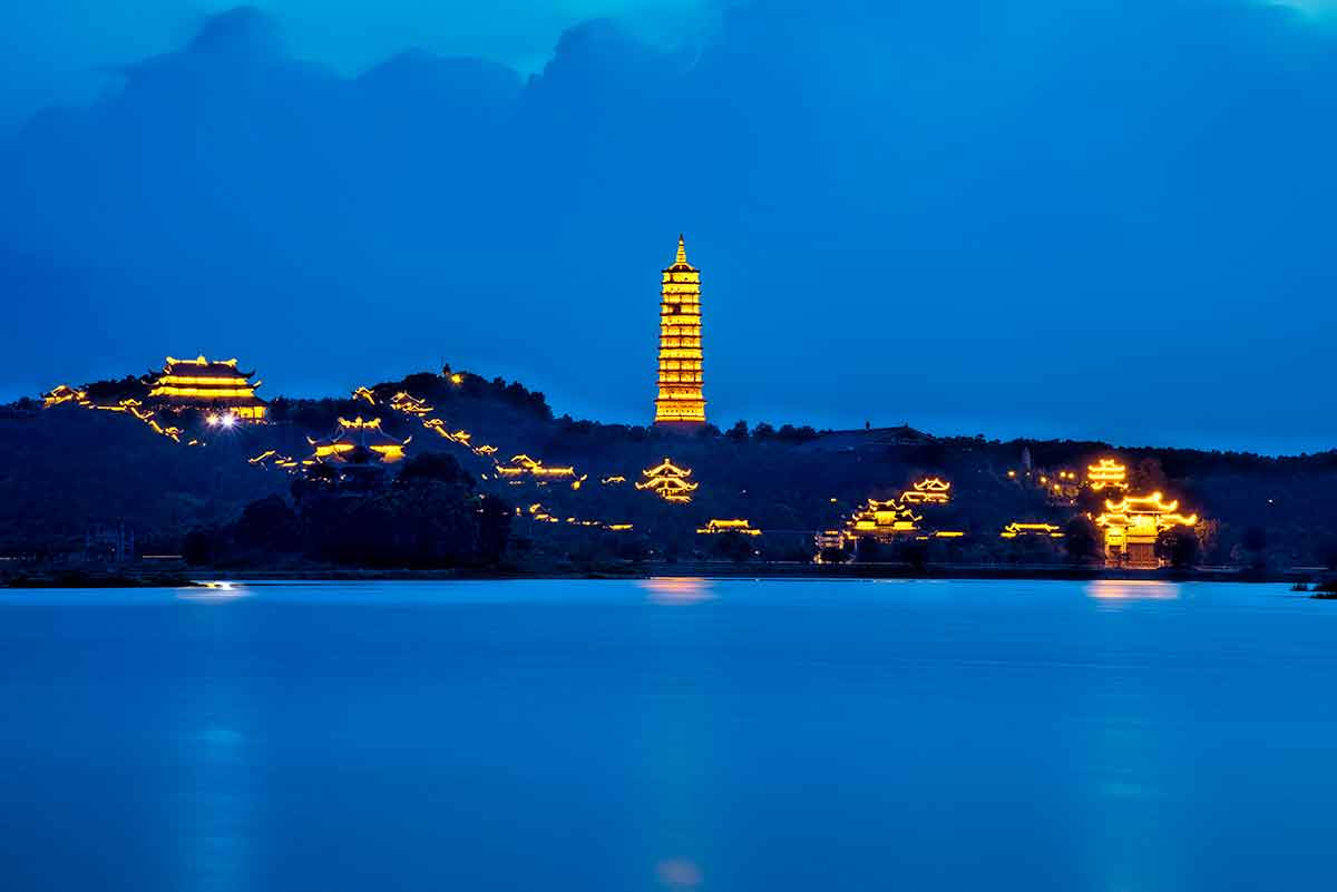Bai Dinh Pagoda at night across the water in Ninh Binh