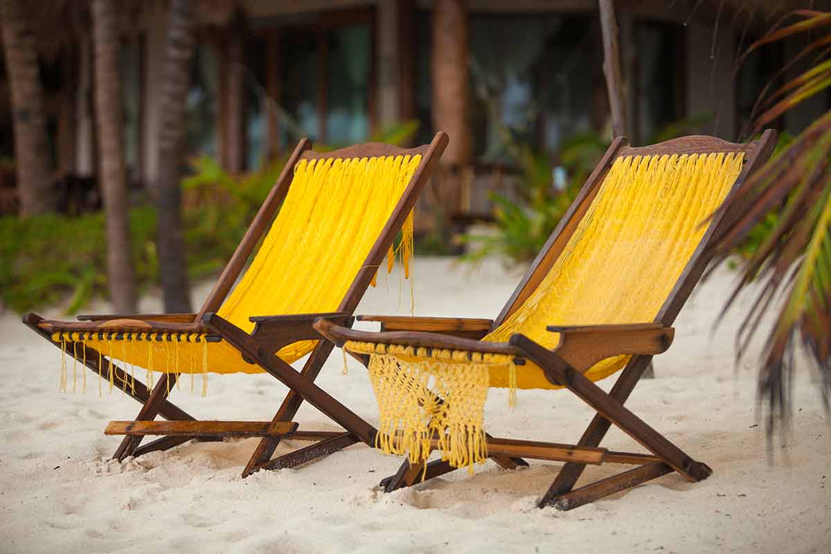 Two chairs on perfect tropical white sand beach in Tulum