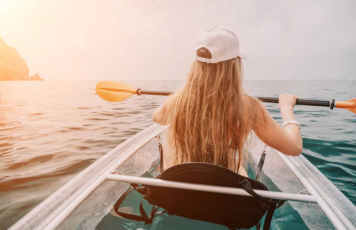 back view of a long-haired woman in a kayak