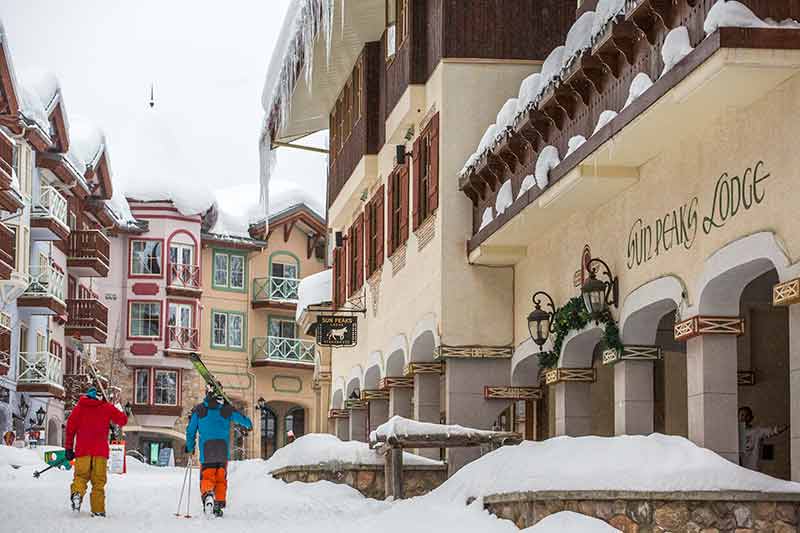 Skiers walking through one of the most charming ski resorts in canada
