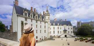 Tourist Girl Visiting The Château Des Ducs De Bretagne