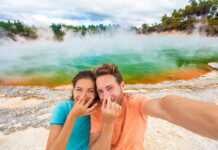 couple holding their noses at the colourful geothermal springs