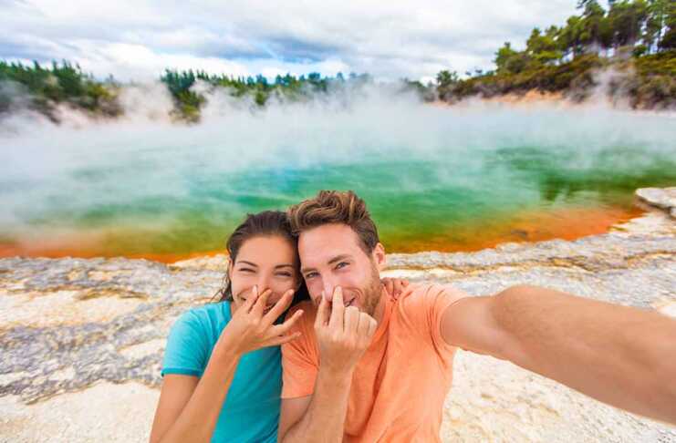 couple holding their noses at the colourful geothermal springs