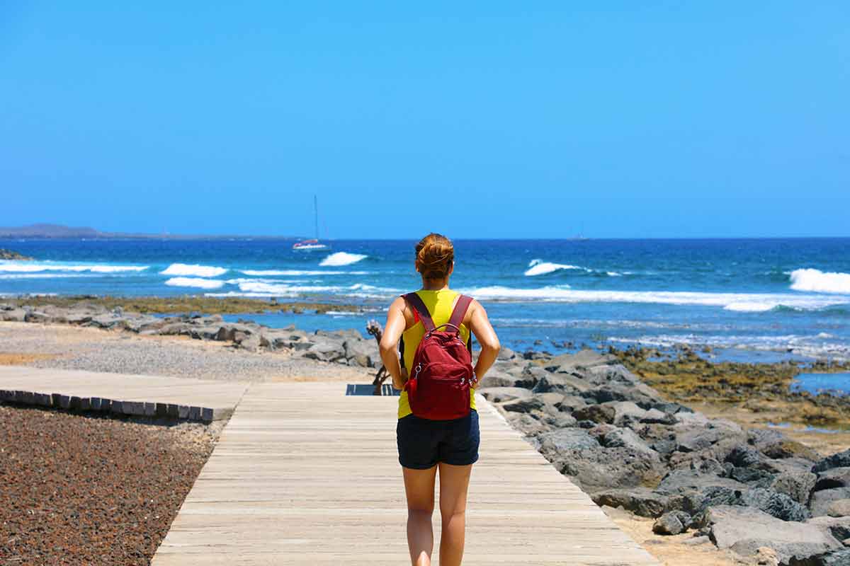 best things to do in tenerife playa de las Americas female hiker walking on catwalk with spectacular landscape