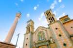 best things to do in tijuana A view of the exterior of the cathedral, the arch, two towers, columns, clock and cross.