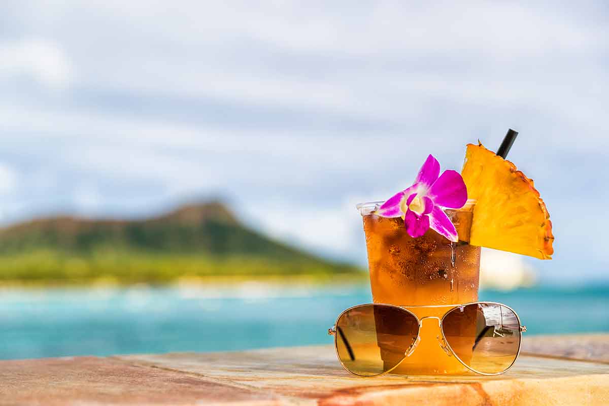 best things to do in waikiki hawaii cocktail with flower, pineapple and sunglasses.