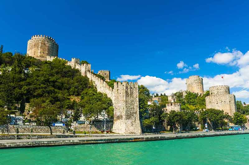 best time of the year to visit turkey castle of Rumeli Hisari blue sky and green water