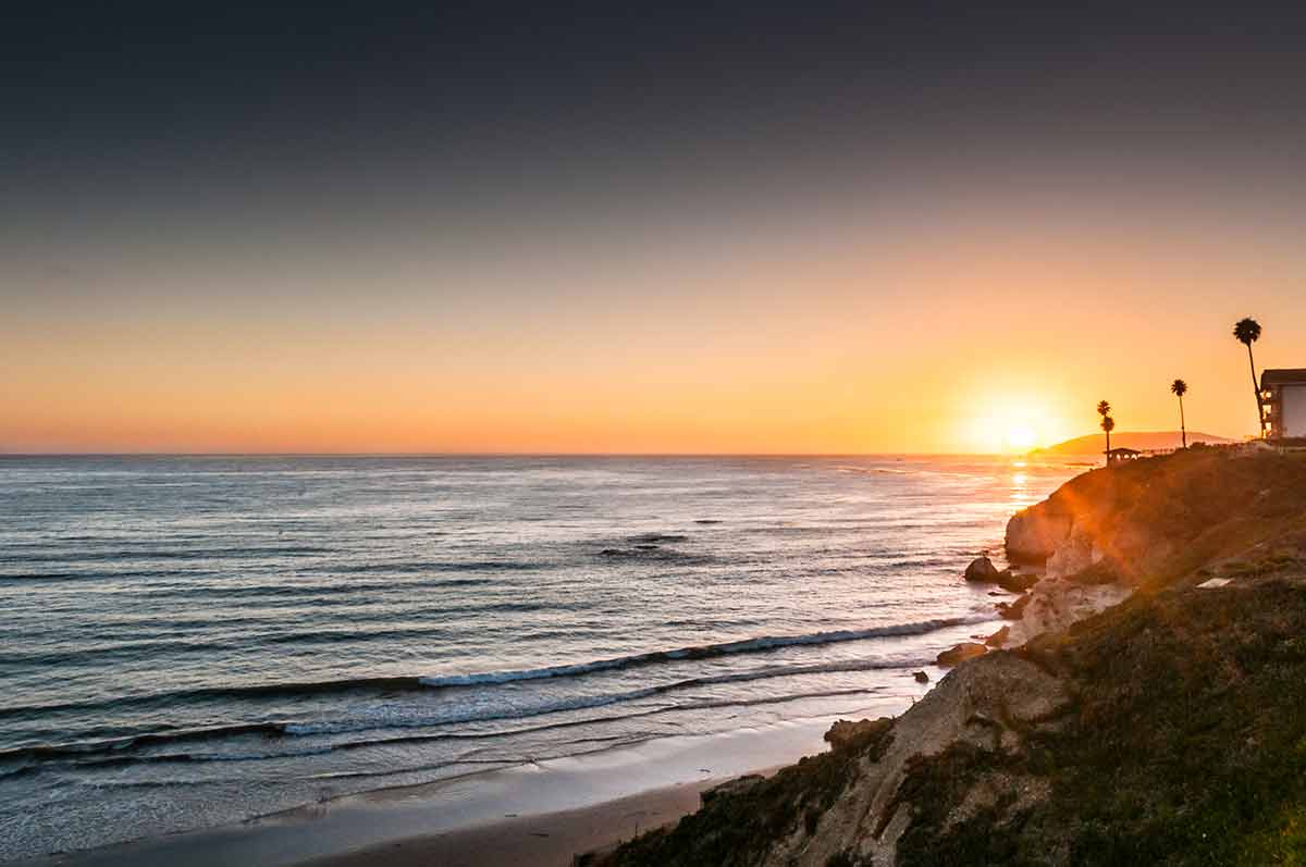 best time to visit california beaches cliff, trees and sunset