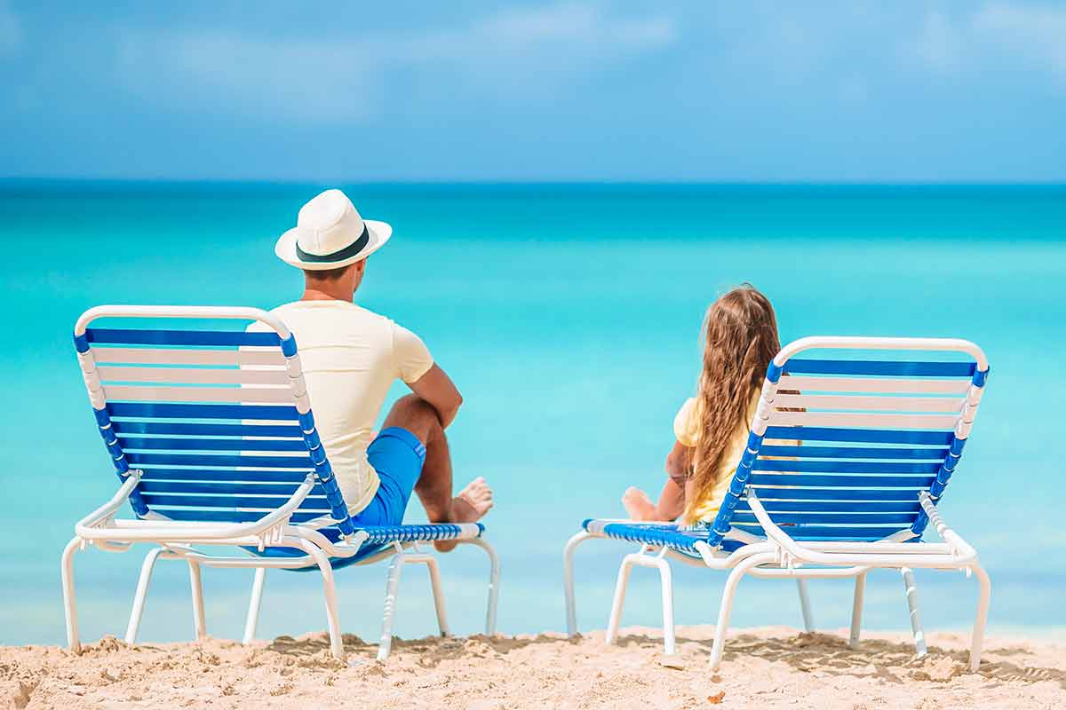 best time to visit cuba weather wise father and daughter on beach lounges