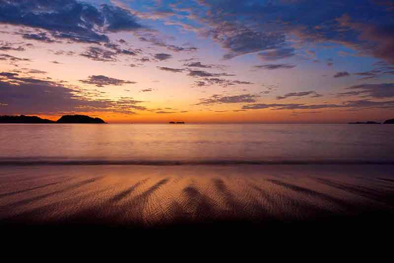 best time to visit guanacaste costa rica purple skies and flowing water at sunset in Guanacaste