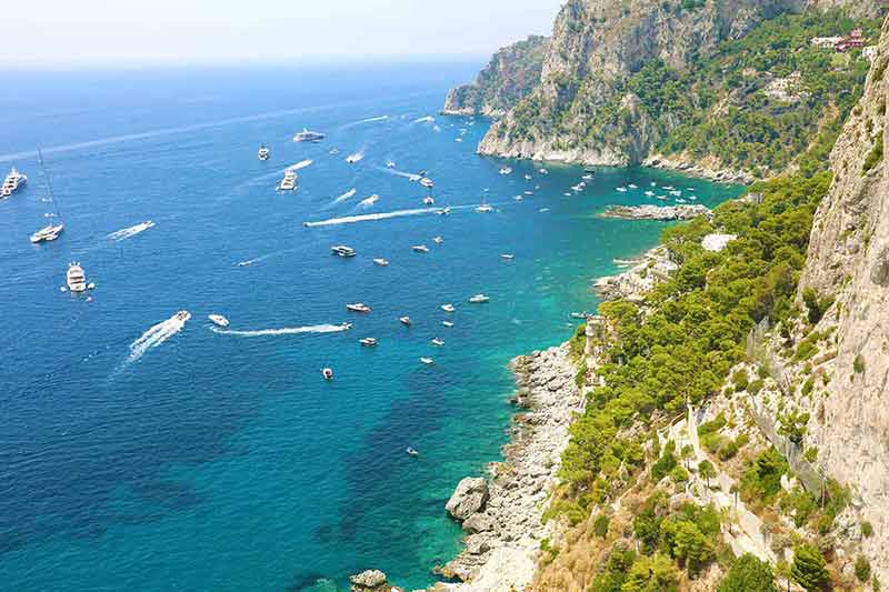 best time to visit italy beaches a beautiful summer day with coastline and boats