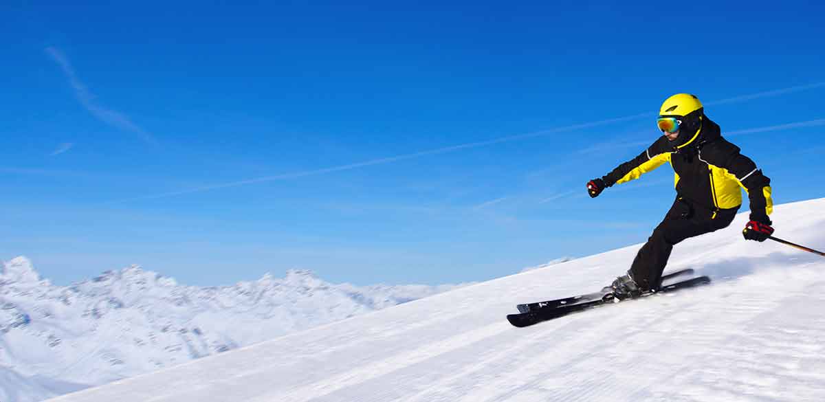 best time to visit kaprun austria skiing Professional alpine skier skiing downhill in high mountains of Alps.