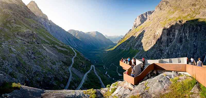 best time to visit norway northern lights people on observation deck over Trollstigen mountain road
