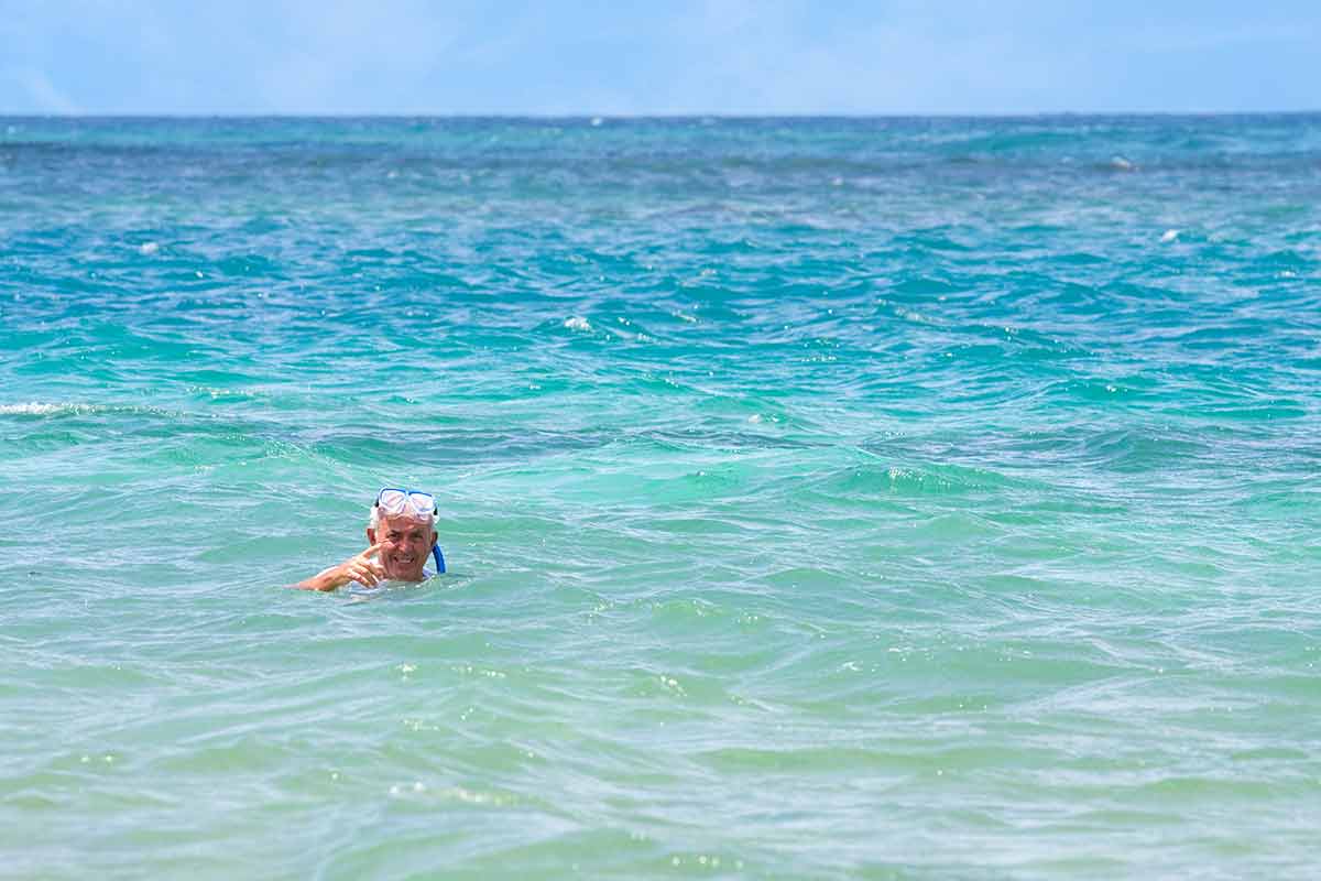 best time to visit san juan puerto rico An older elderly man snorkels in tropical waters