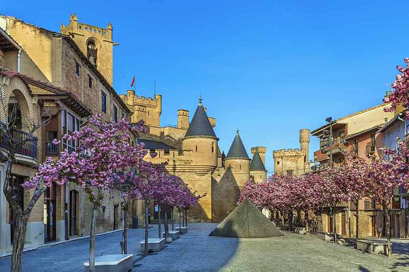 best time to visit spain navarre olite castle with cherry blossom trees