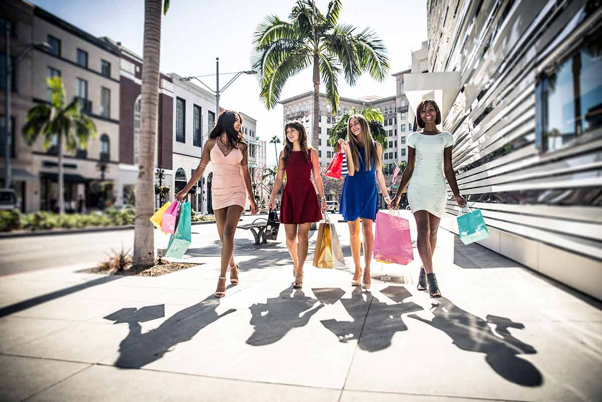 beverly hills things to do four women carrying shopping bags walking down the street