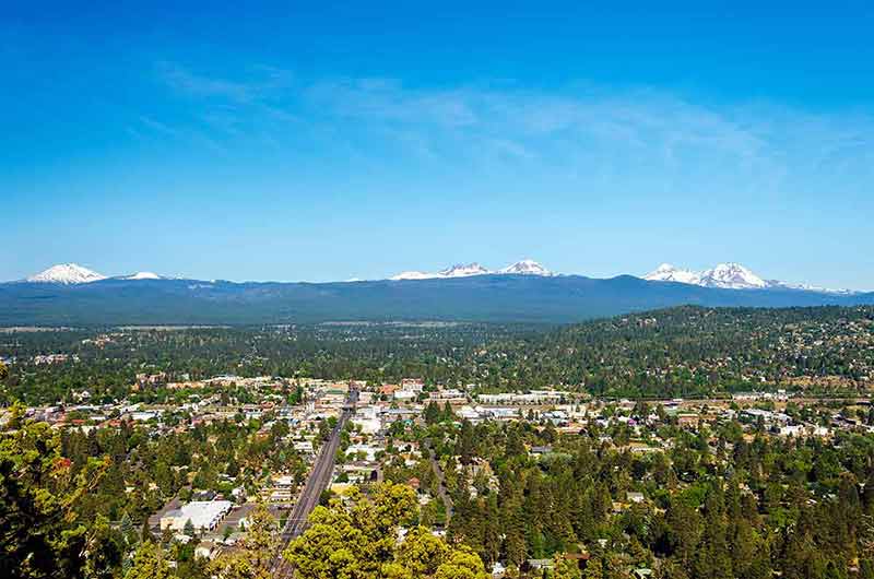 Cascade Mountains in the distance and aerial view of Bend