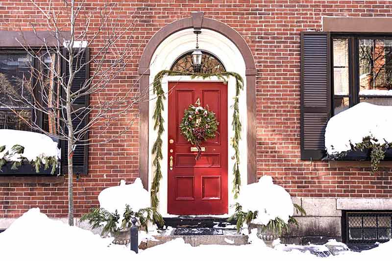 red door decorated with wreath