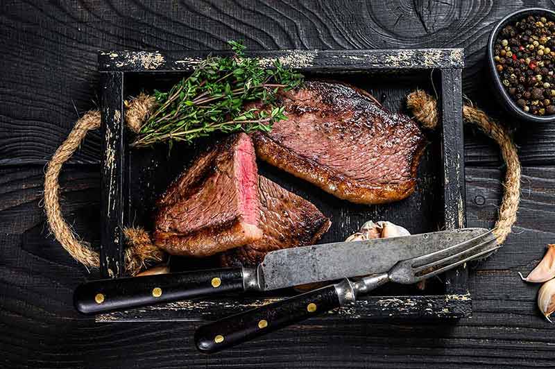 brazil best time to visit juicy beef steak in a black timber tray
